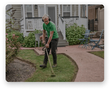 lawn care specialist cuts edges of the lawn